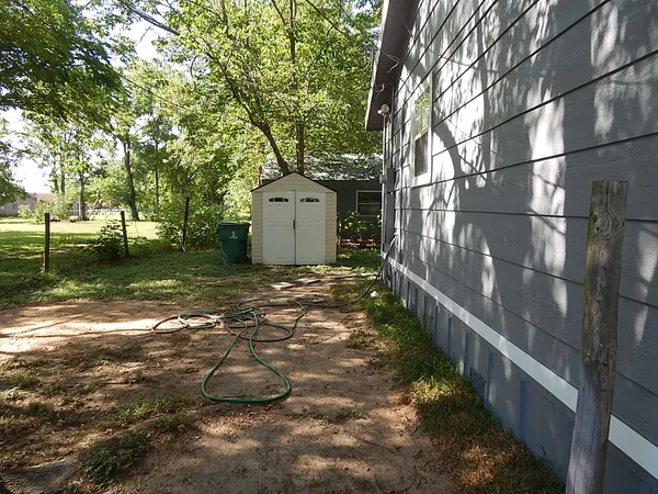 a view of a small house with a yard