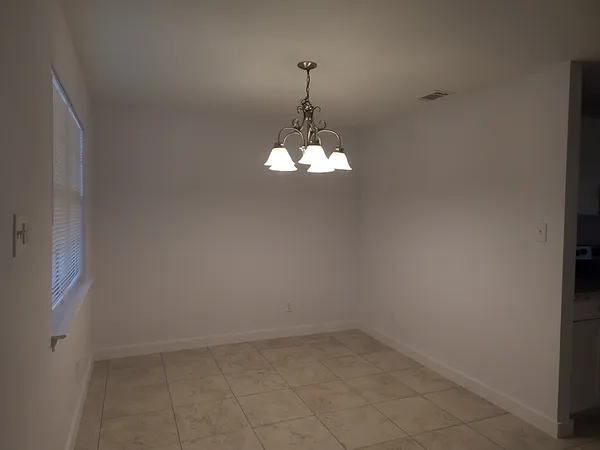 a room that has a chandelier and a window