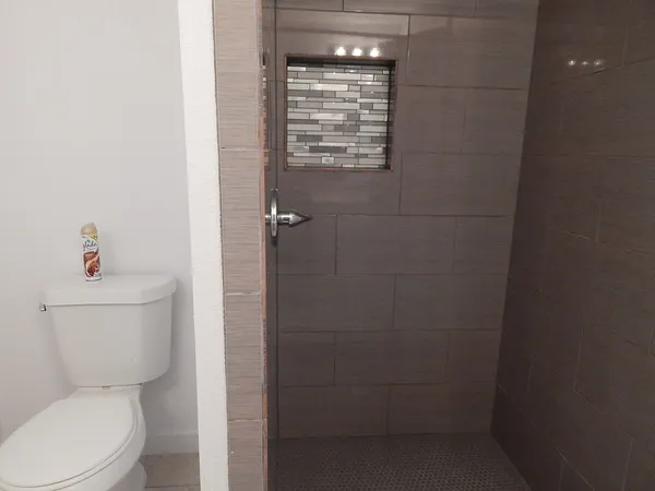 a white toilet sitting next to a bathroom sink