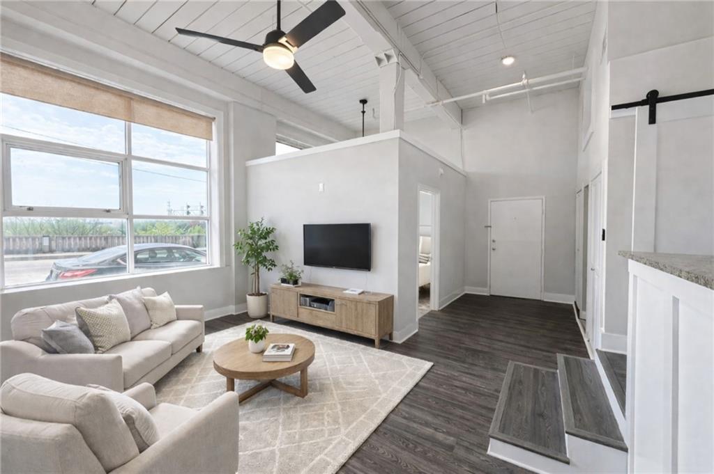 161 Mangum Street Southwest, Unit 204 Atlanta, GA 30313 - Photo 11 of 24 a living room with furniture and a flat screen tv