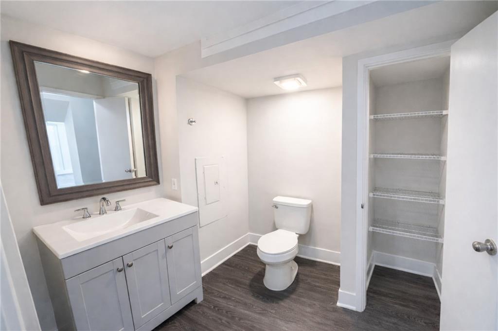 161 Mangum Street Southwest, Unit 204 Atlanta, GA 30313 - Photo 15 of 24 a bathroom with a toilet sink and a mirror