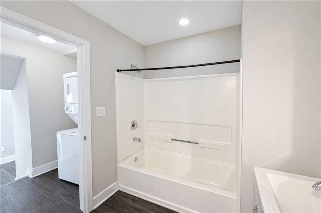 161 Mangum Street Southwest, Unit 204 Atlanta, GA 30313 - Photo 16 of 24 a bathroom with a bathtub and a shower