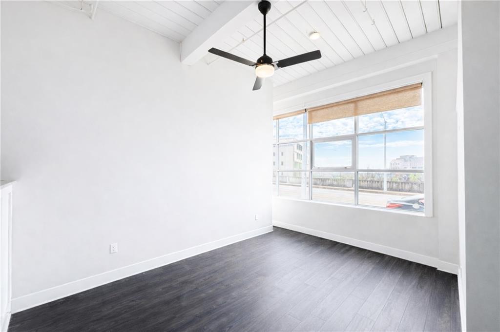 161 Mangum Street Southwest, Unit 204 Atlanta, GA 30313 - Photo 7 of 24 a view of a livingroom with wooden floor a ceiling fan and window