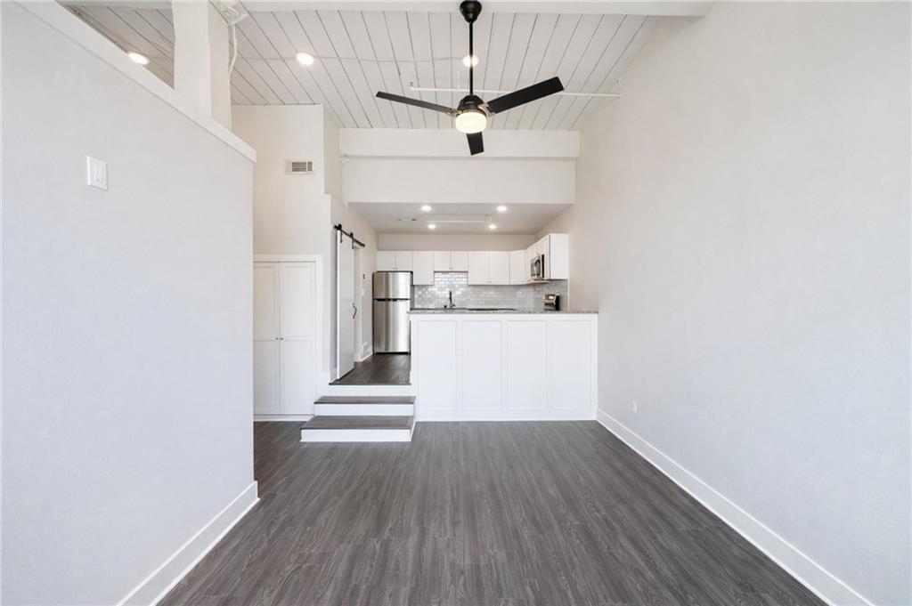 161 Mangum Street Southwest, Unit 204 Atlanta, GA 30313 - Photo 8 of 24 a view of a kitchen with wooden floor and a sink