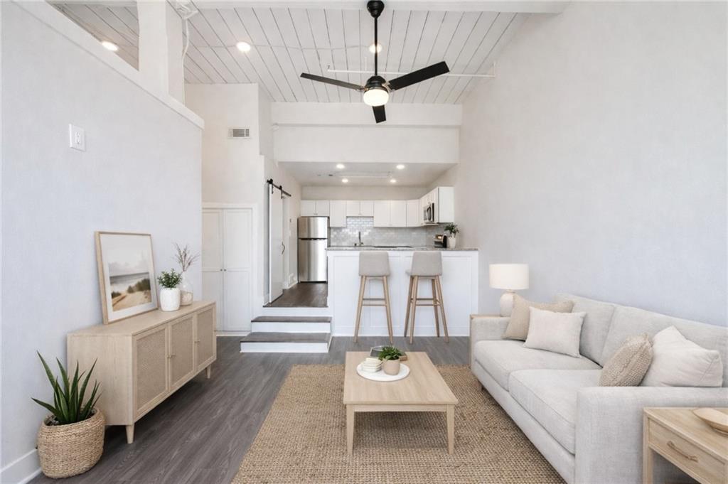 161 Mangum Street Southwest, Unit 204 Atlanta, GA 30313 - Photo 9 of 24 a living room with furniture and a chandelier