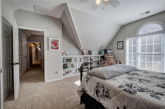 a living room with furniture a flat screen tv and a floor to ceiling window