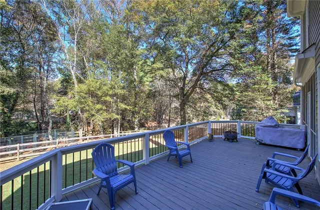 a aerial view of a house with a yard and large trees