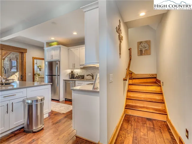 a view of kitchen with sink and refrigerator