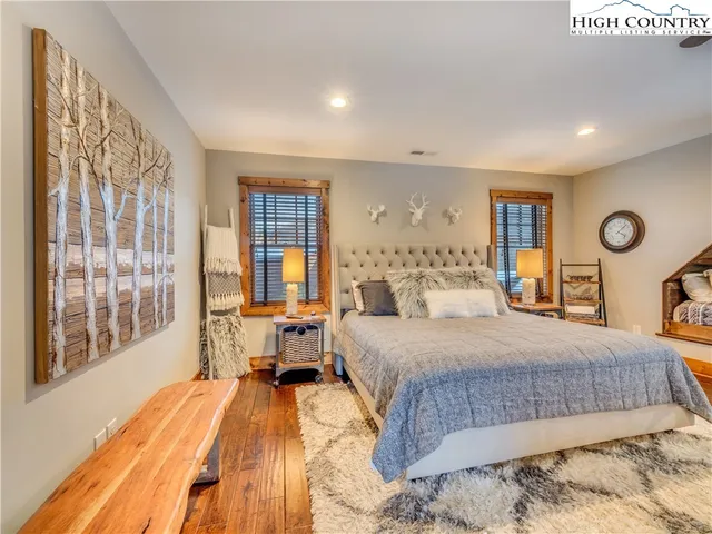 a bedroom with a large bed and a large window