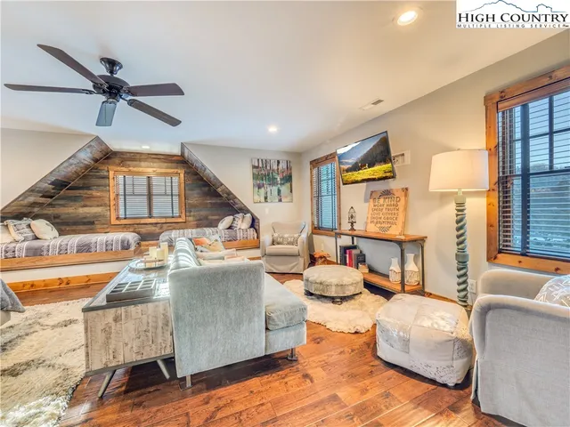 a living room with fireplace furniture and a large window