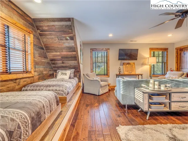 a spacious bedroom with a bed a couch and dresser in it