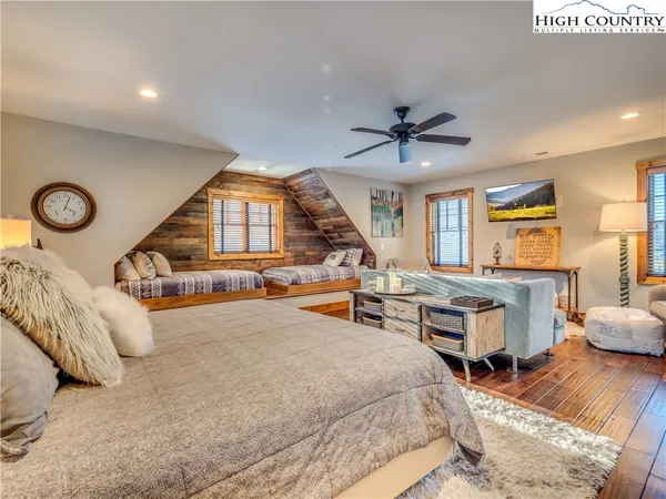 a bedroom with furniture and a large window