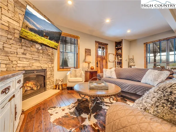 a living room with furniture a fireplace and a dining table