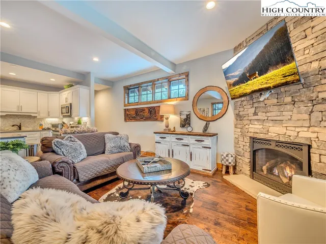 a living room with furniture a clock and a fireplace