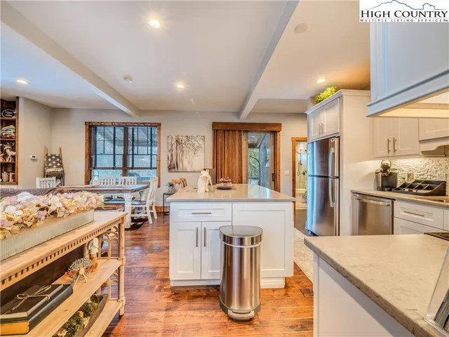 a large kitchen with stainless steel appliances granite countertop a stove and a refrigerator