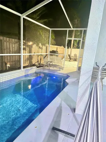 a view of a backyard with sitting area