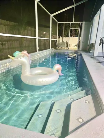 a living room with furniture a wooden floor and a chandelier