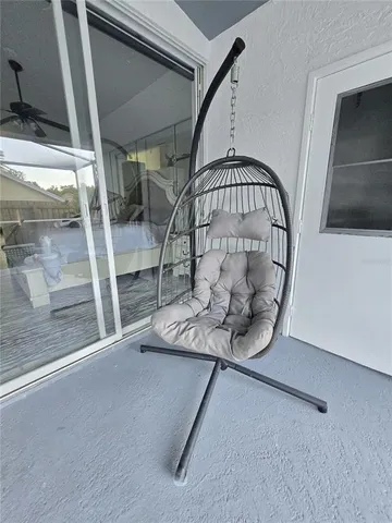 a living room with furniture and a ceiling fan