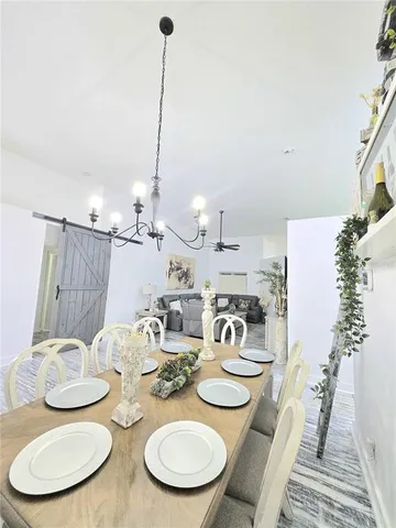 a living room with stainless steel appliances wooden floor and a fireplace
