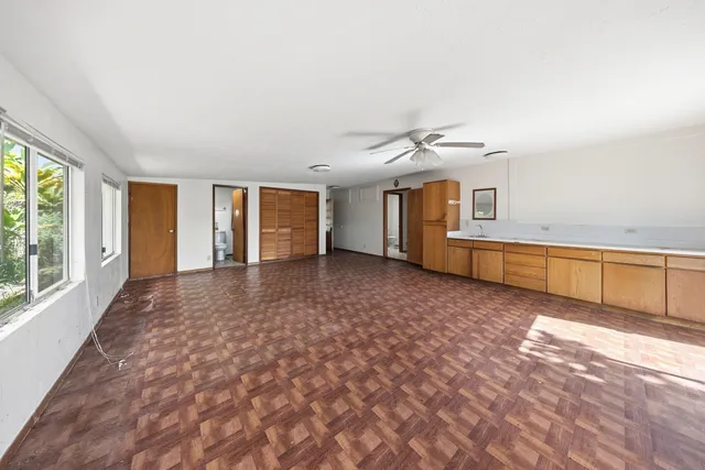 a view of a livingroom with an empty space and a window