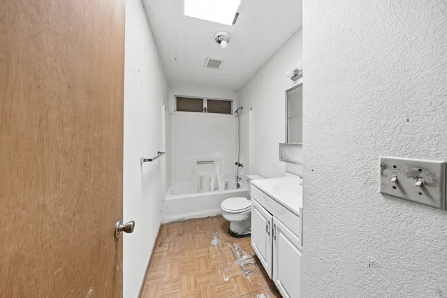 a bathroom with a double vanity sink toilet and shower