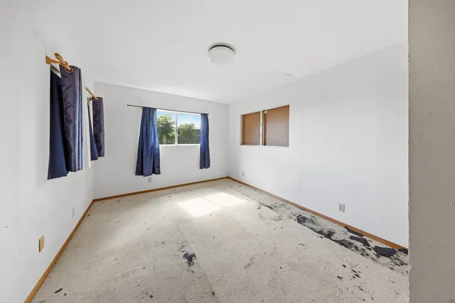 a view of an empty room with windows