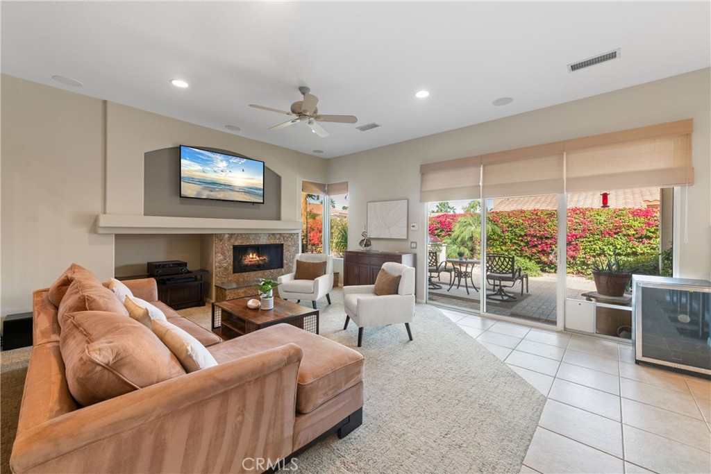 70 Rocio Court Palm Desert, CA 92260 - Photo 12 of 40 a living room with furniture fireplace and a large window