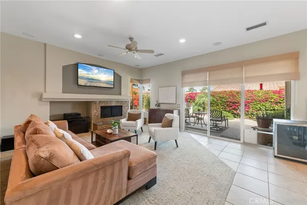a living room with furniture fireplace and a large window