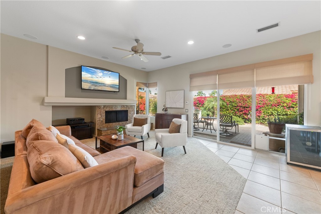 70 Rocio Court Palm Desert, CA 92260 - Photo 13 of 40 a living room with furniture fireplace and a large window