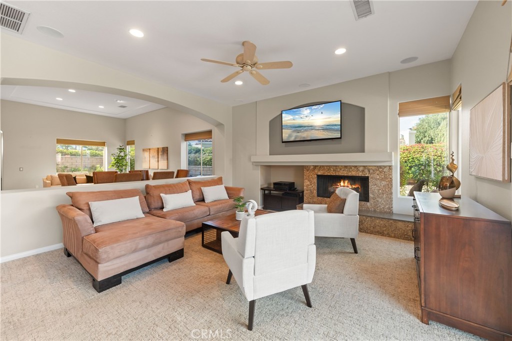 70 Rocio Court Palm Desert, CA 92260 - Photo 14 of 40 a living room with furniture and a fireplace