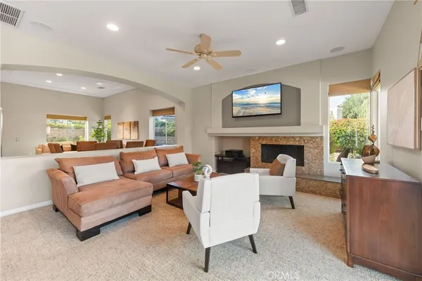a living room with furniture a fireplace and a flat screen tv