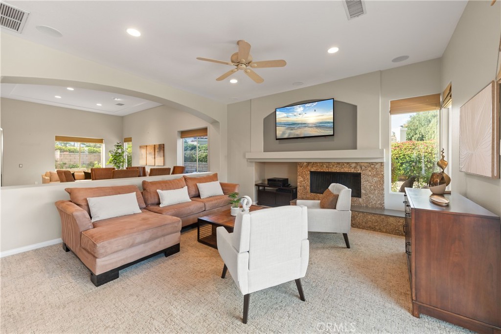 70 Rocio Court Palm Desert, CA 92260 - Photo 15 of 40 a living room with furniture a fireplace and a flat screen tv