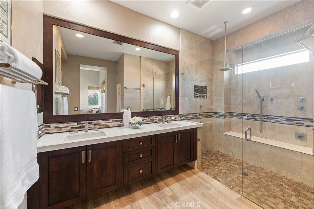 70 Rocio Court Palm Desert, CA 92260 - Photo 24 of 40 a bathroom with a tub sink double vanity and mirror