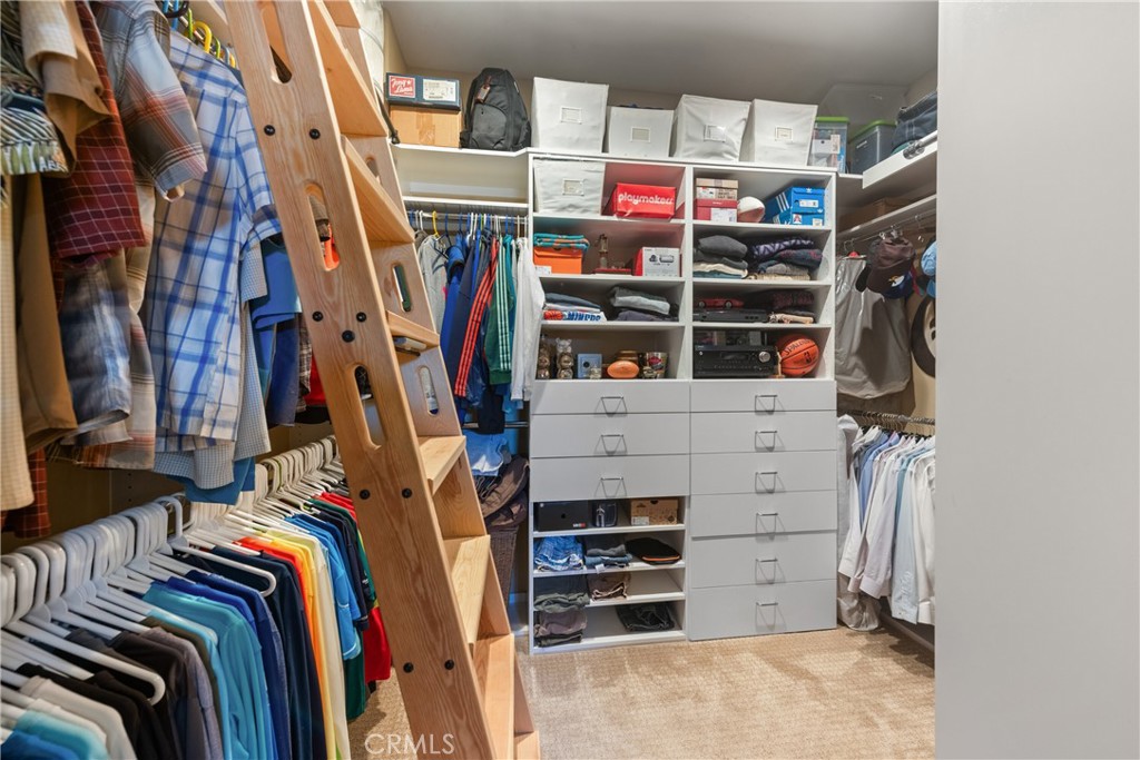 70 Rocio Court Palm Desert, CA 92260 - Photo 25 of 40 a view of walk in closet with clothes and shoes