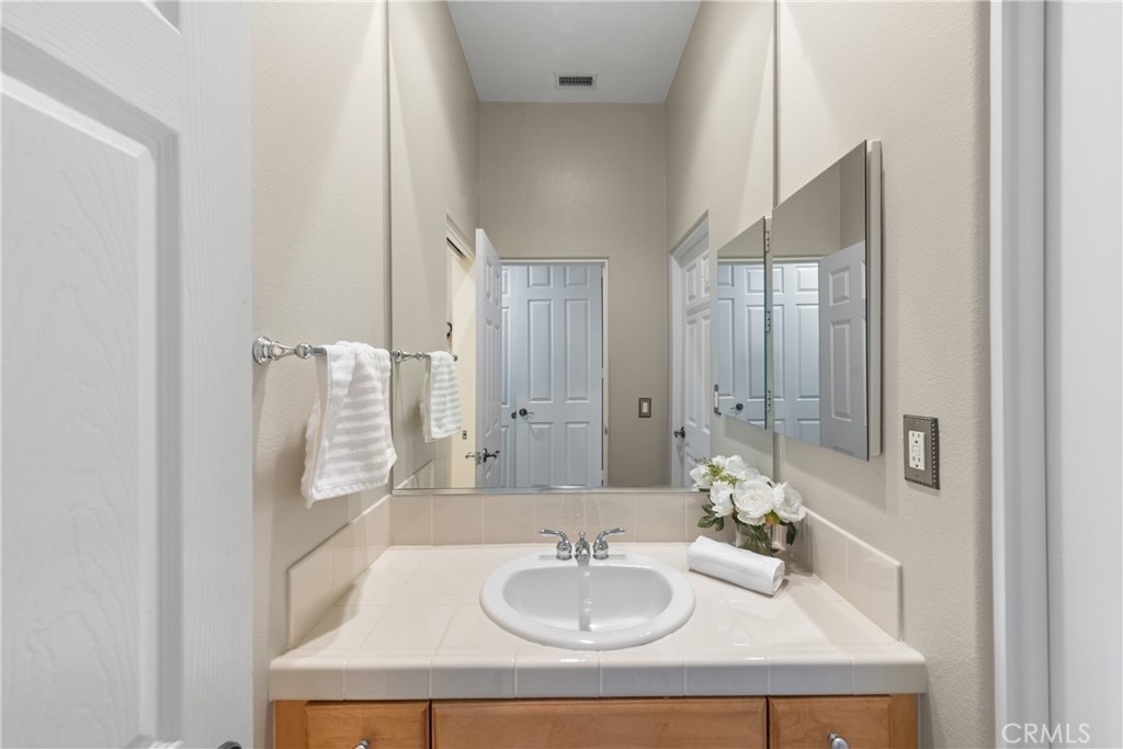 70 Rocio Court Palm Desert, CA 92260 - Photo 28 of 40 a bathroom with a sink and a mirror
