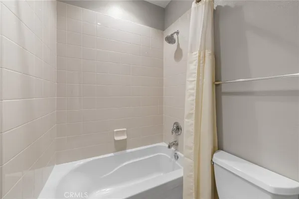 a bathroom with a toilet and bathtub