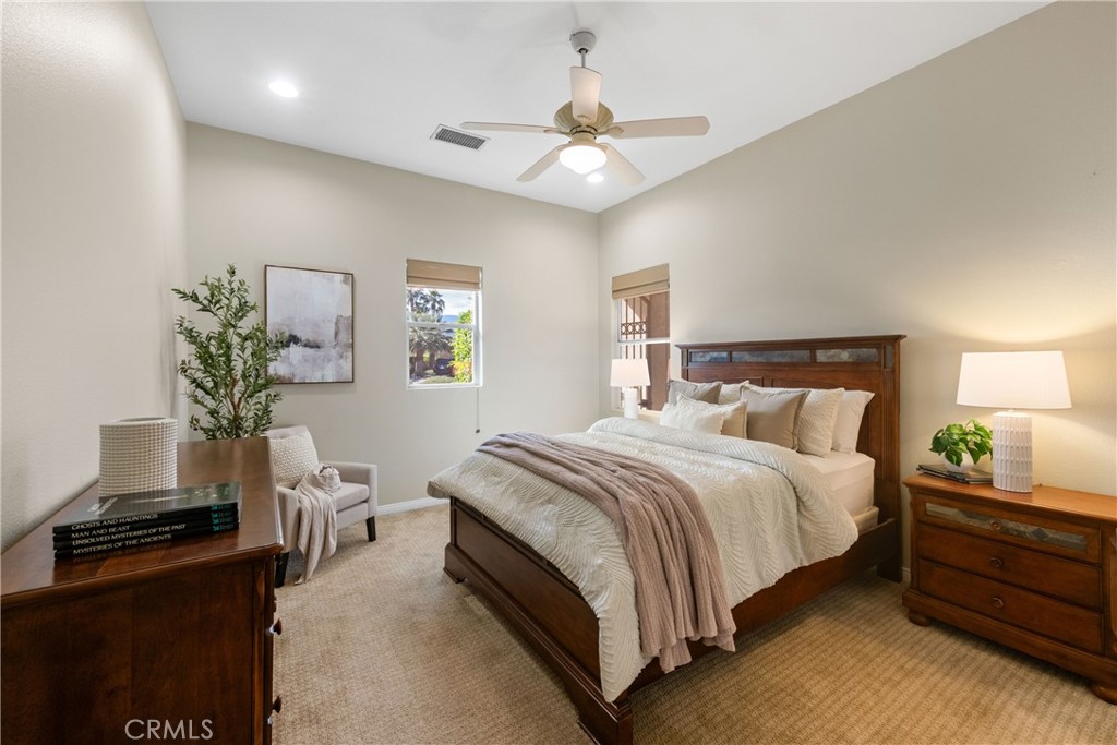 70 Rocio Court Palm Desert, CA 92260 - Photo 30 of 40 a bedroom with a bed and a potted plant on the dresser