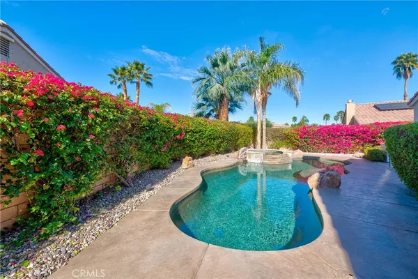 a view of a swimming pool with a yard
