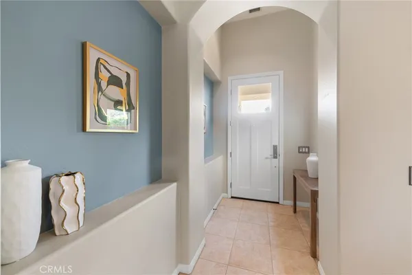 a view of a hallway with windows and stairs