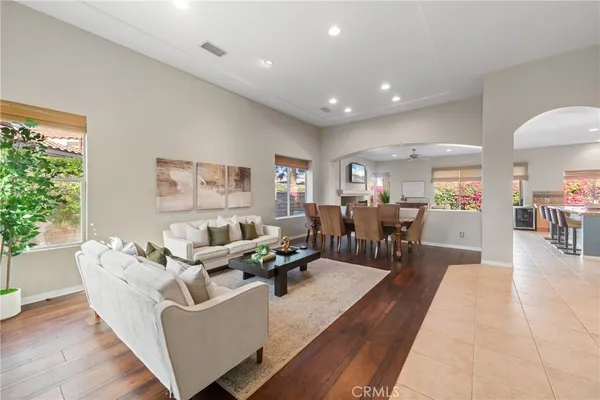 a living room with furniture and wooden floor