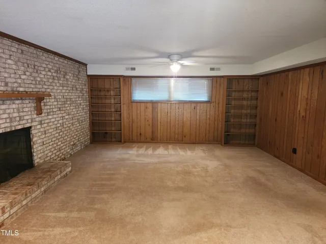 a view of an empty room with a fireplace