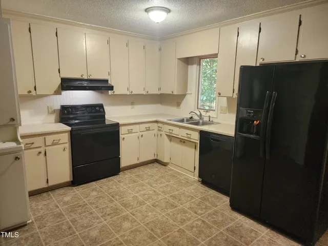 a kitchen with a sink stove and refrigerator