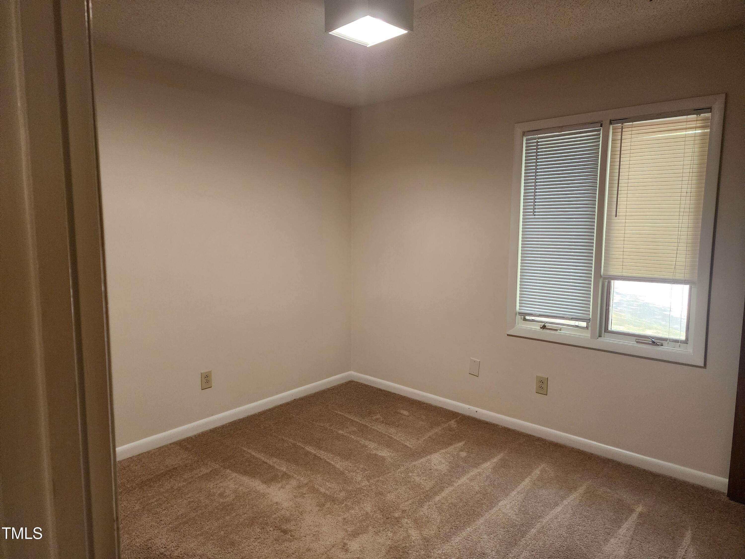 3304 Boulder Court Raleigh, NC 27607 - Photo 5 of 19 an empty room with a window