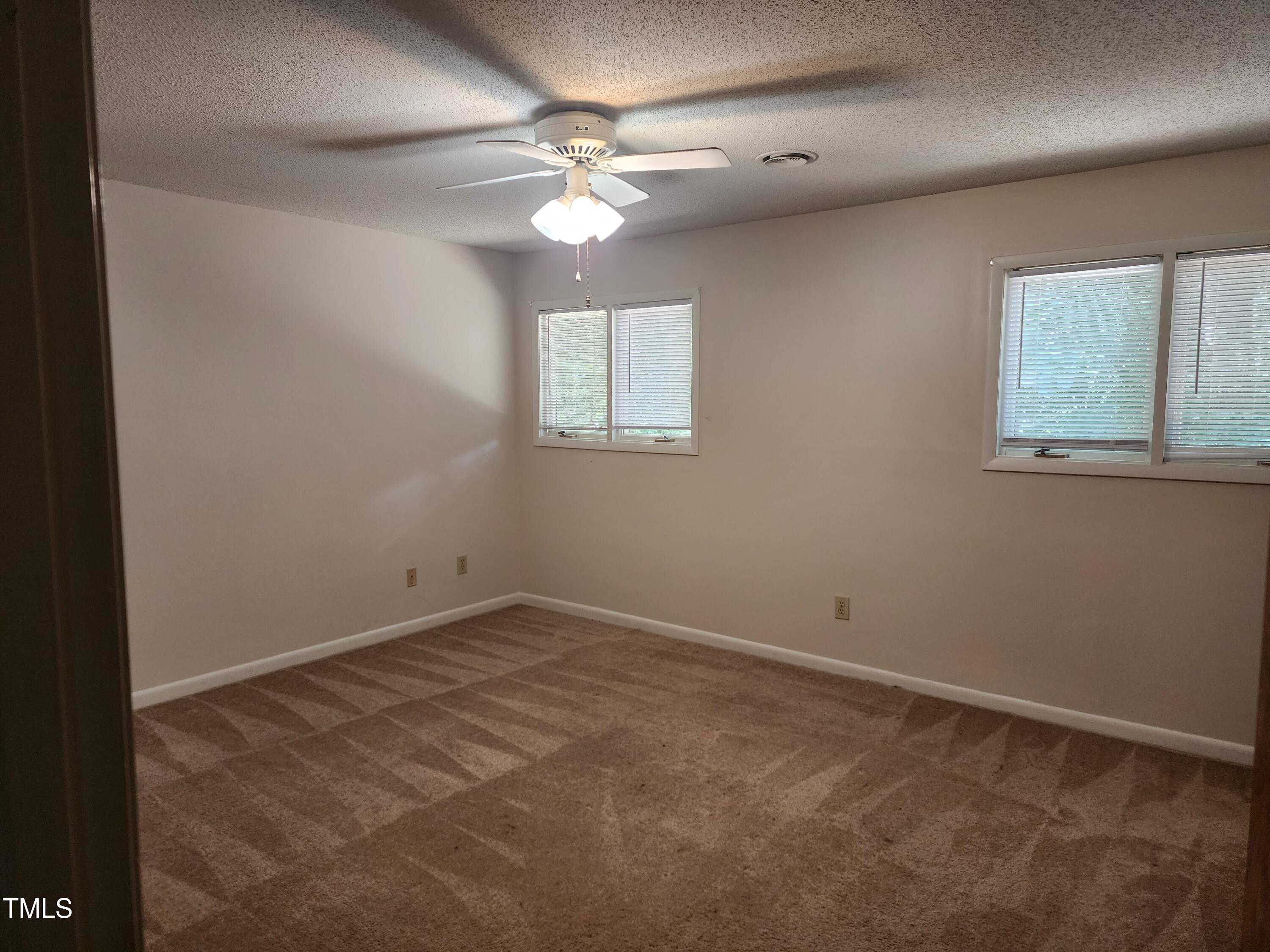 3304 Boulder Court Raleigh, NC 27607 - Photo 6 of 19 an empty room with a chandelier fan