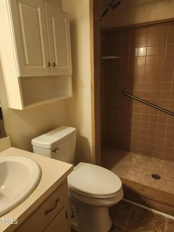 a bathroom with a toilet and a shower