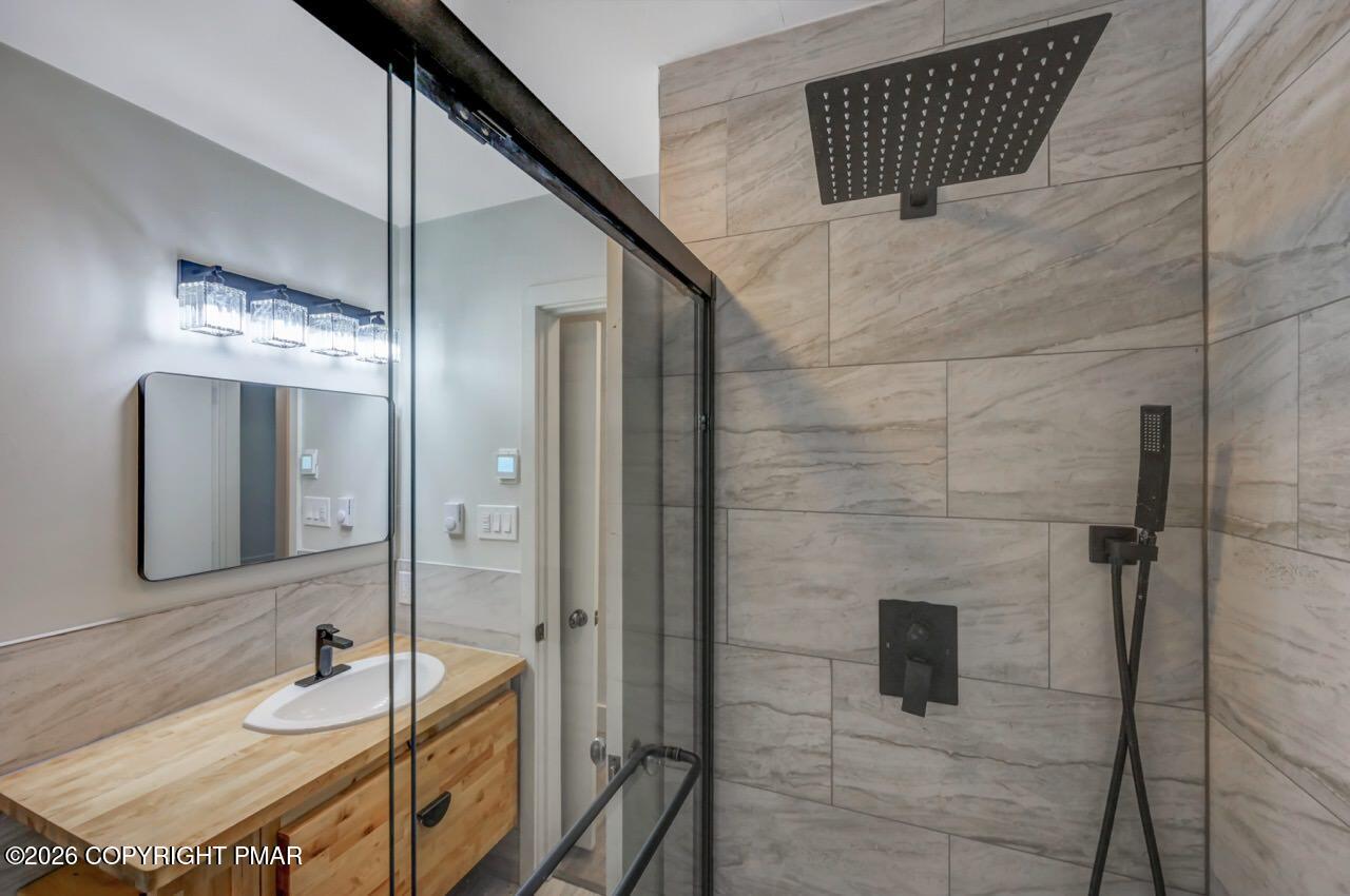 384 Devils Hole Road Cresco, PA 18326 - Photo 47 of 97 a bathroom with a sink and a mirror