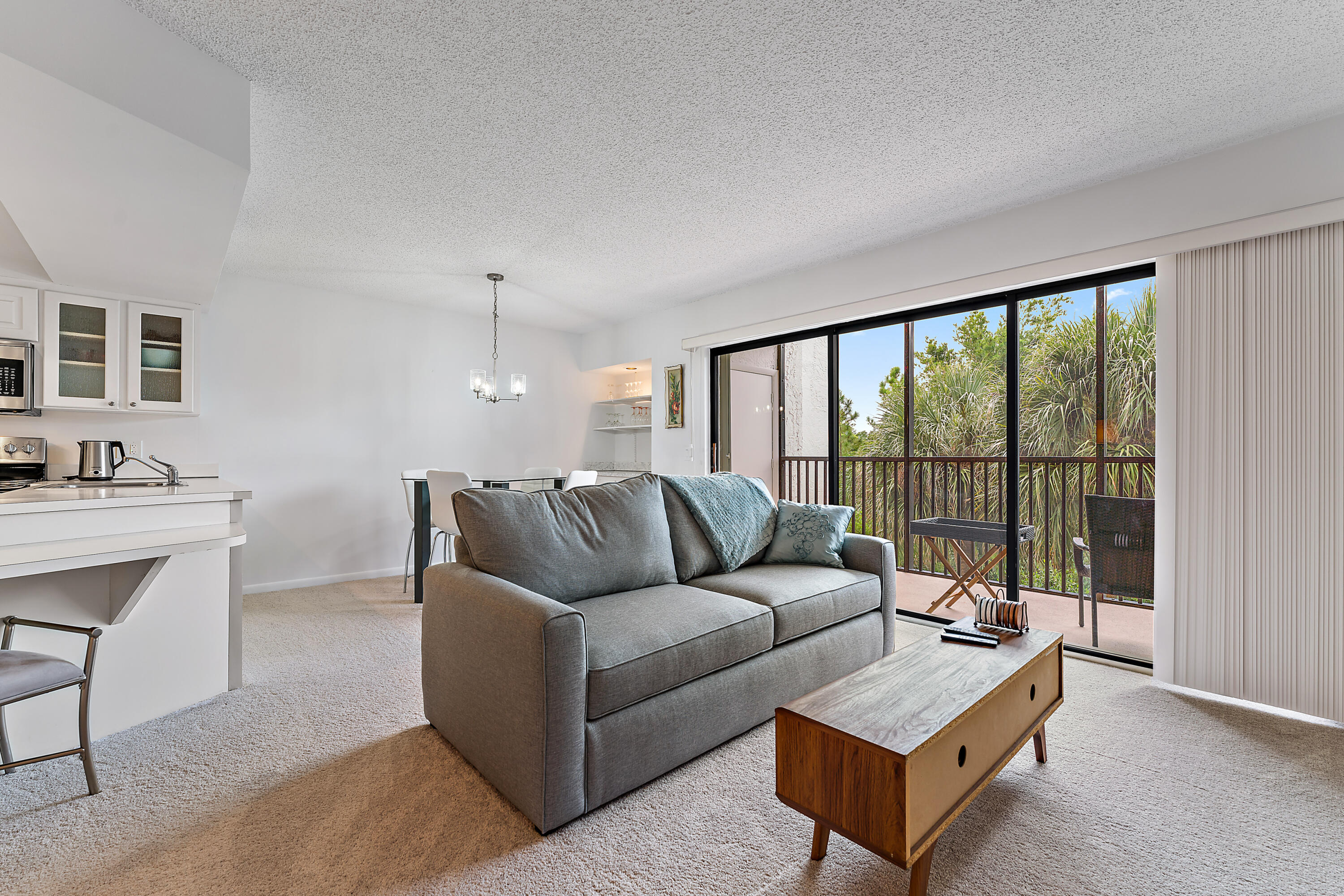 1605 Highway 1, Unit F305 Jupiter, FL 33477 - Photo 16 of 31 a living room with furniture and a floor to ceiling window