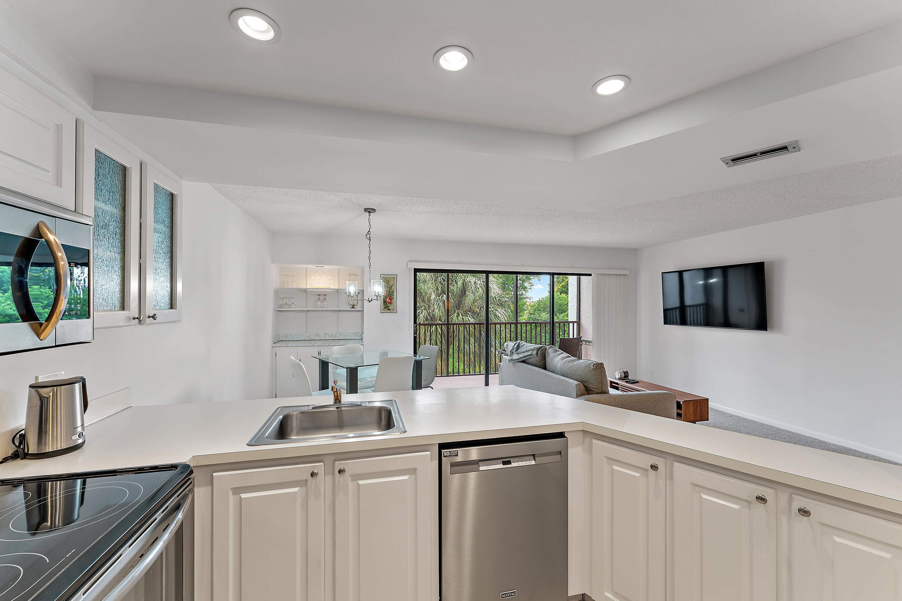 1605 Highway 1, Unit F305 Jupiter, FL 33477 - Photo 18 of 31 a kitchen that has a sink and a stove in it