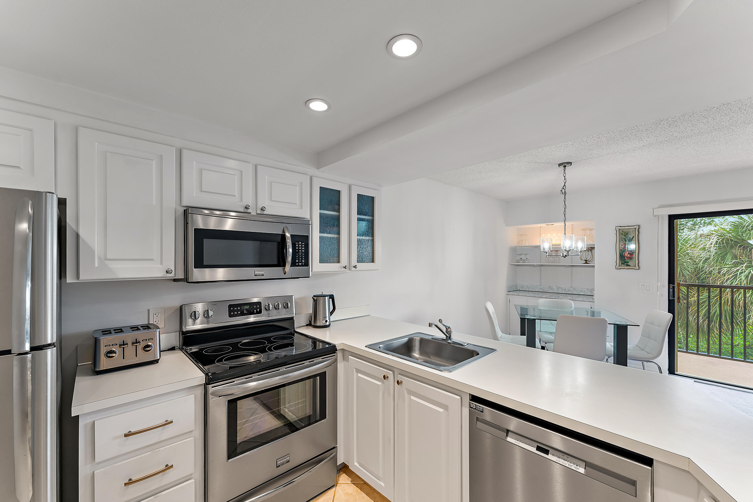 1605 Highway 1, Unit F305 Jupiter, FL 33477 - Photo 19 of 31 a kitchen that has a sink and a stove top oven