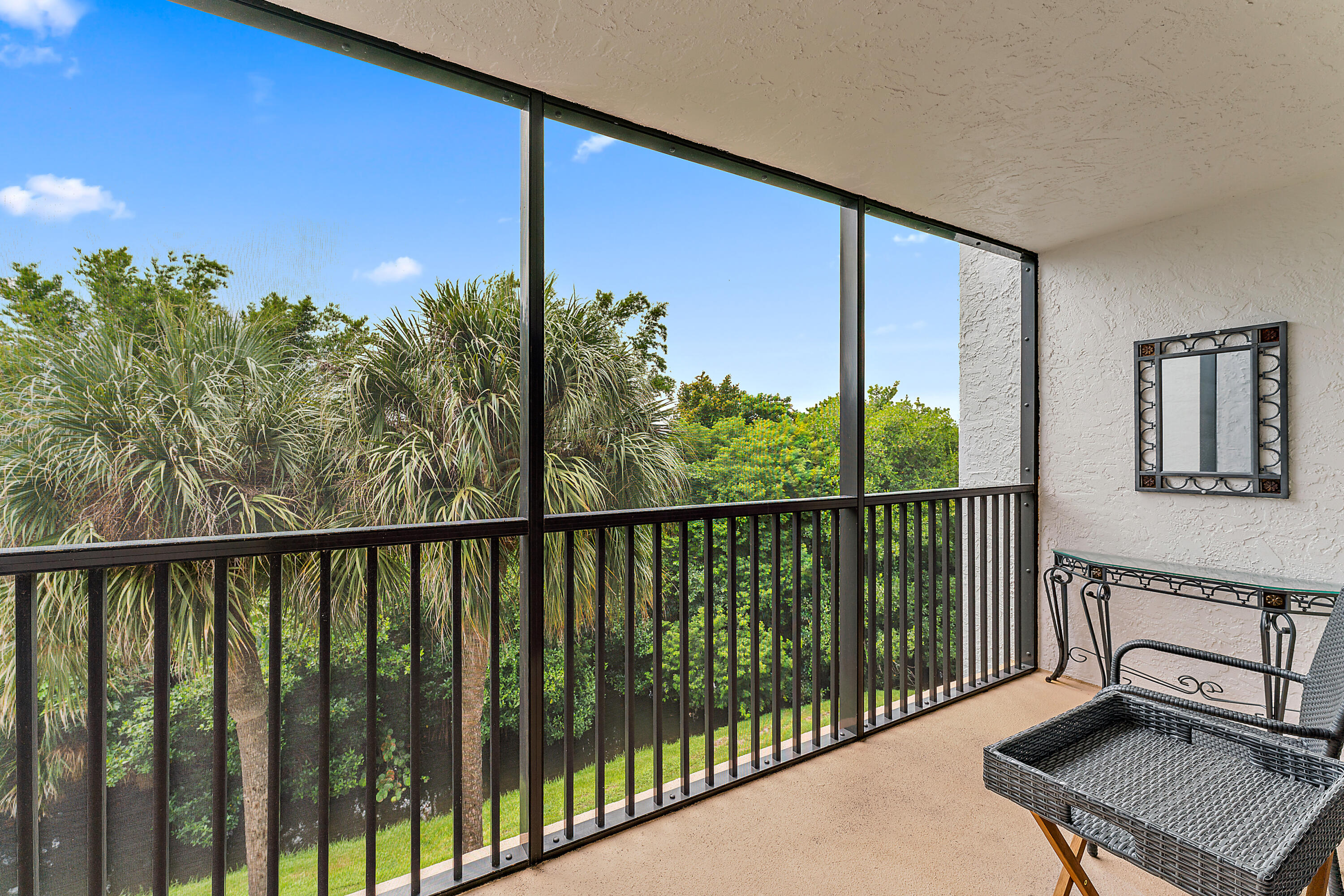 1605 Highway 1, Unit F305 Jupiter, FL 33477 - Photo 2 of 31 a view of a balcony with chair and wooden fence